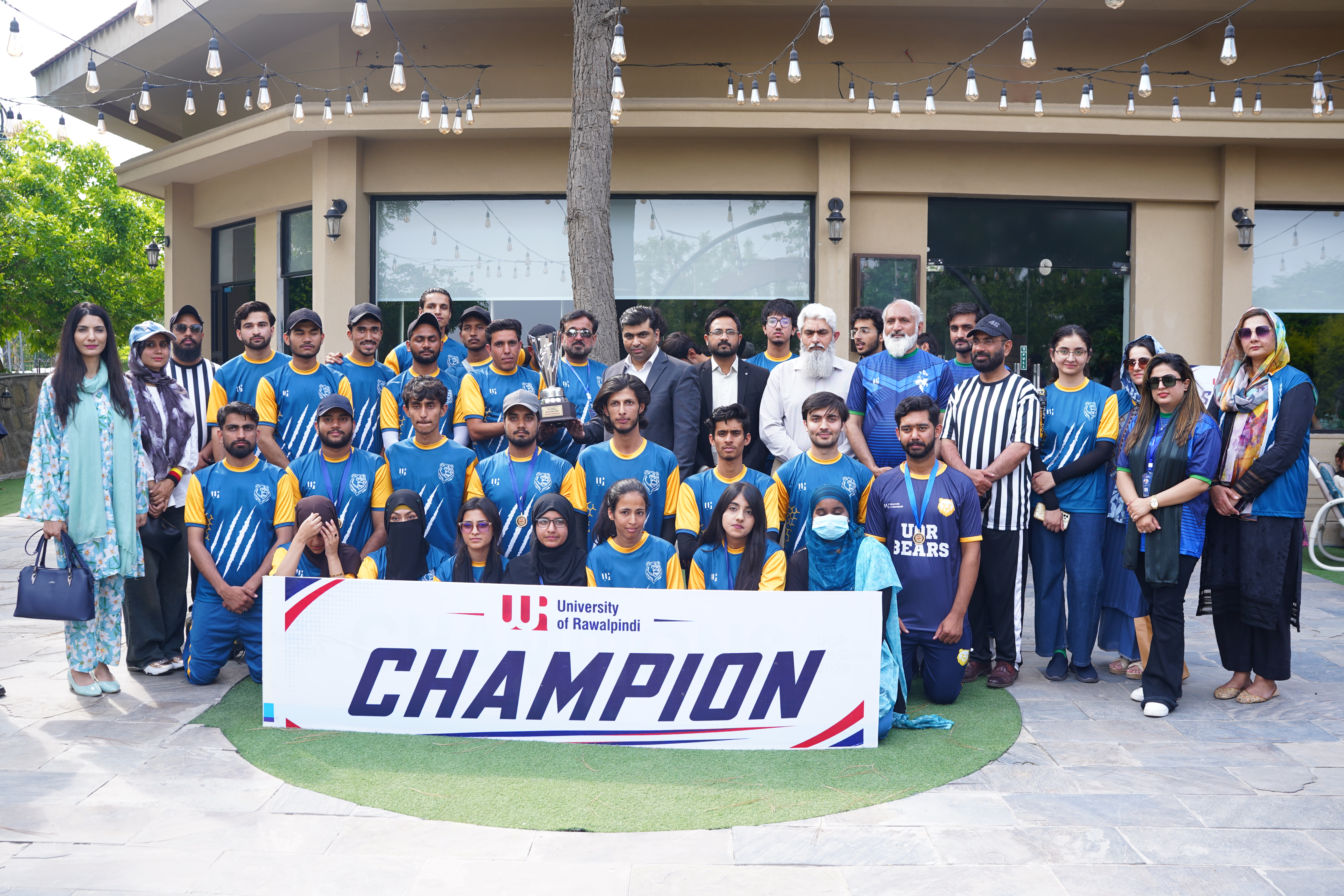 University of Rawalpindi championship team celebrating with their trophy