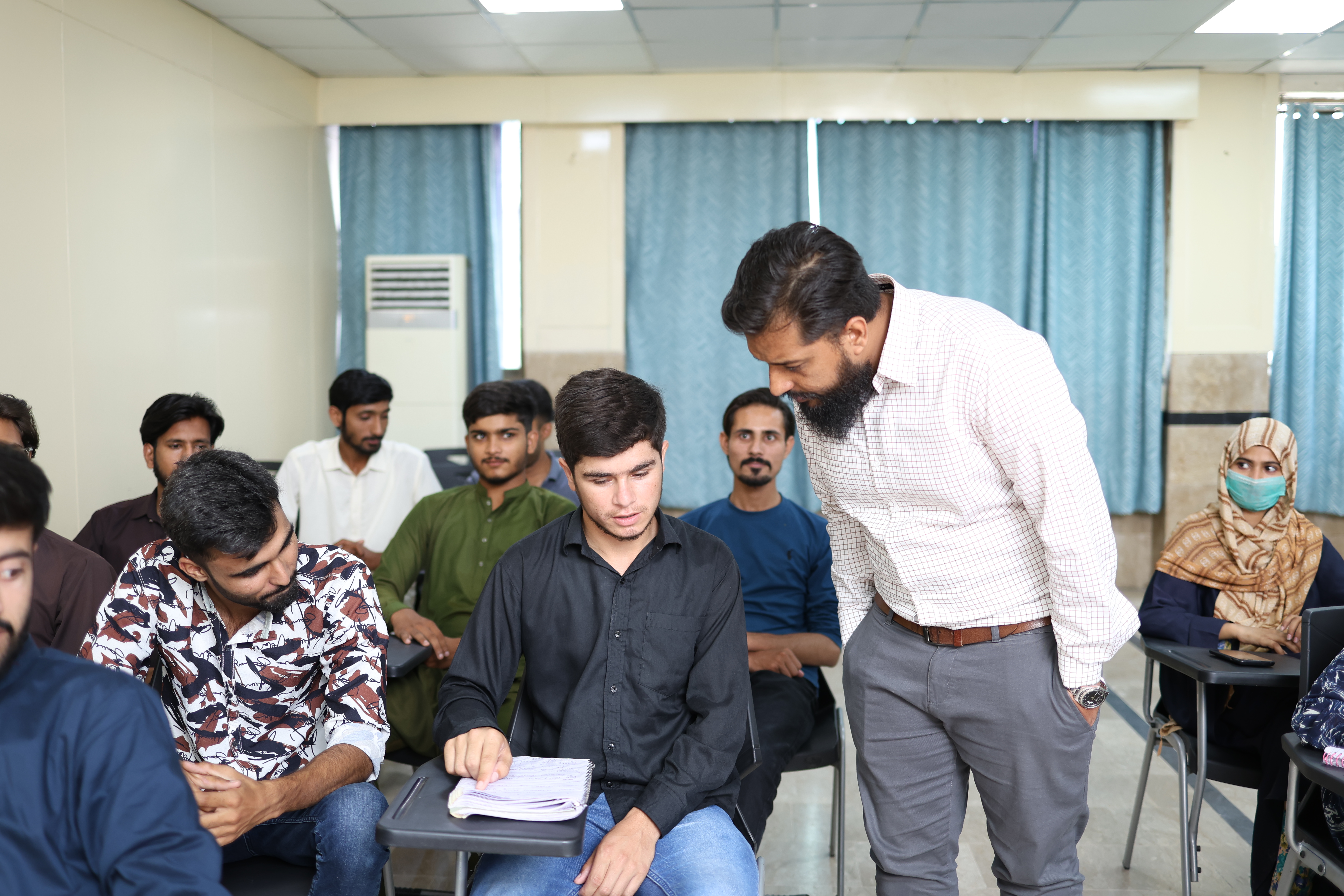 UOR faculty member mentoring students during a classroom session
